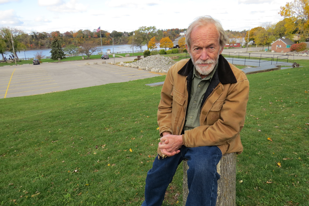 Lance Henriksen sits in front of the Lewiston waterfront.
