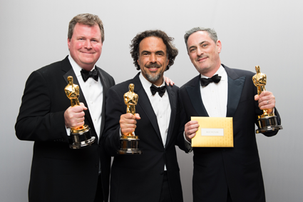 Academy Awards: Pictured, from left: James W. Skotchdopole, Alejandro G. Iñárritu and John Lesher pose backstage with the Oscar for Best Motion Picture of the Year. They won for 
