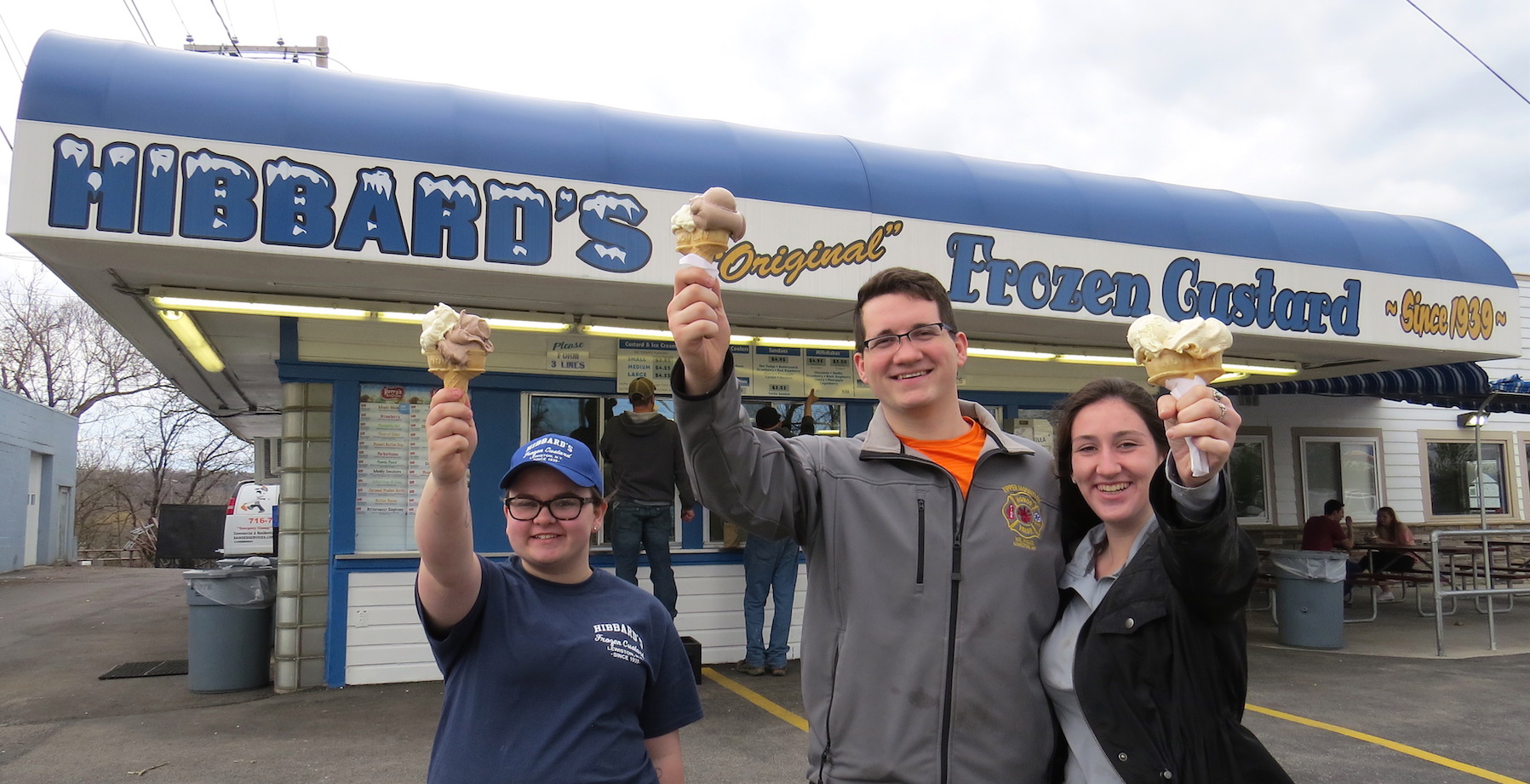 Max Jacobson of Lewiston and Emily Virgil of Rochester celebrate their first Hibbard's Original Frozen Custard stop of the season on Monday. Employee Gabby Ott joins them outside the stand.