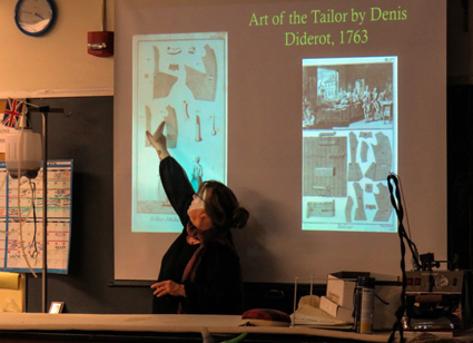 Niagara County Historian Kate Emerson presents historic details of the men's 18th century waistcoat to Niagara University students as a contributor to a collaborative project between Old Fort Niagara and the university.