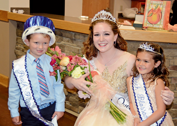 Lindsey Clark was crowned Peach Queen Sunday night. She is shown, at right, with Peach Blossom Julianna Vanderhider, age 6, the daughter of Wayne and Kristy Vanderhider, and Peach Fuzz Jack Thomas Sliwowski, 5, the son of Tony and Meaghan Sliwowski. (Photo by Robin Clark)