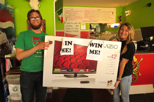 Matt and Maddie hold the 42-inch Vizio E Series Smart LED HDTV, which one lucky Spicey Pickle customer will win Tuesday, May 5.
