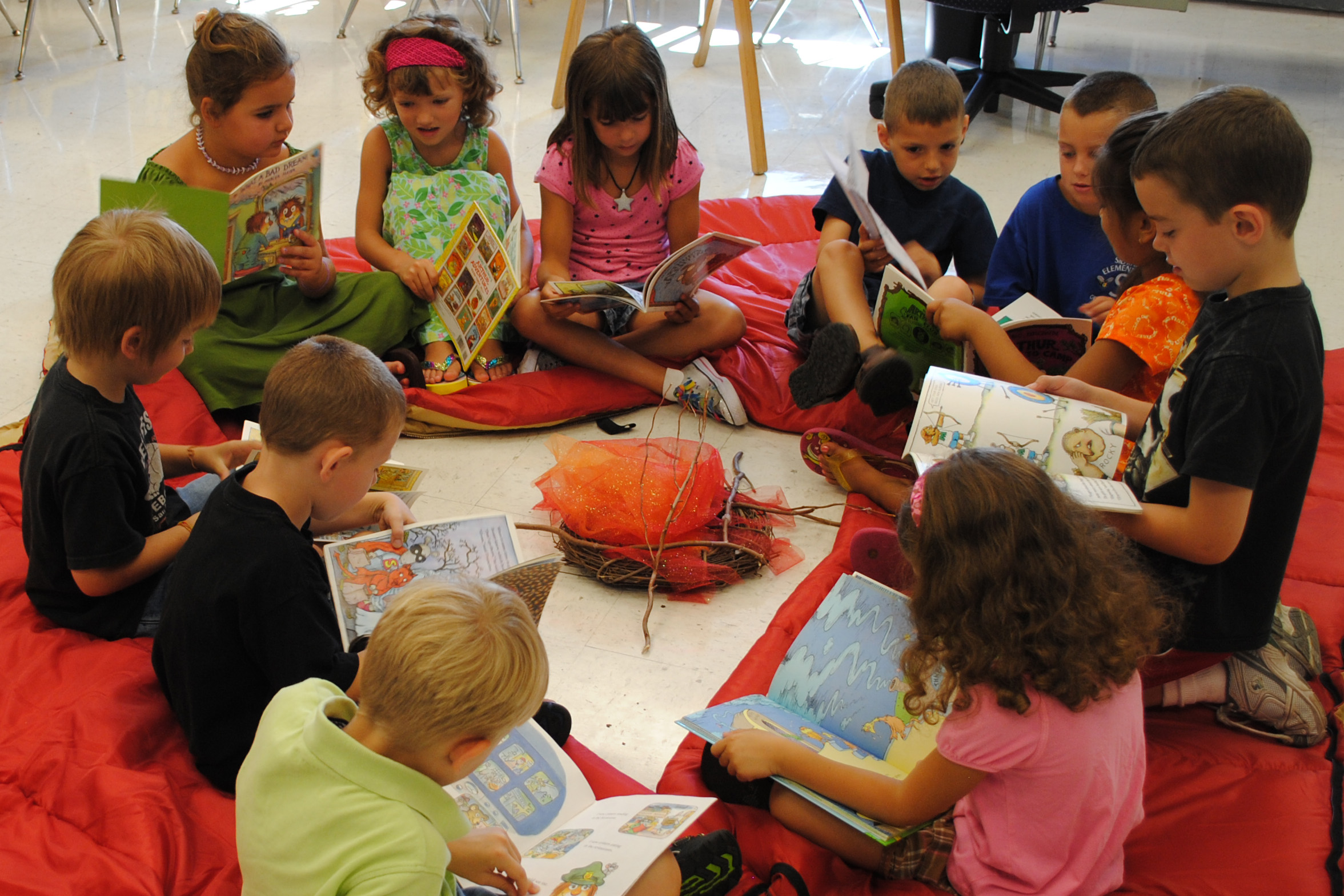 Students read around a campfire at Camp Sidway.