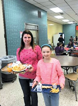 Assistant Principal Danielle Wallenhorst Hawkins goes to lunch shadowing sixth-grader Savanna.