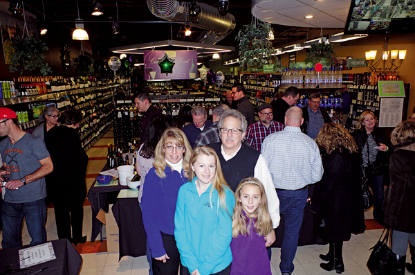 Kim and Sam Aceti and their daughters Melina and Marissa celebrated a 10th year anniversary Dec. 2 at their business, Aceti's Wine & Spirits. (Photos by Larry Austin)