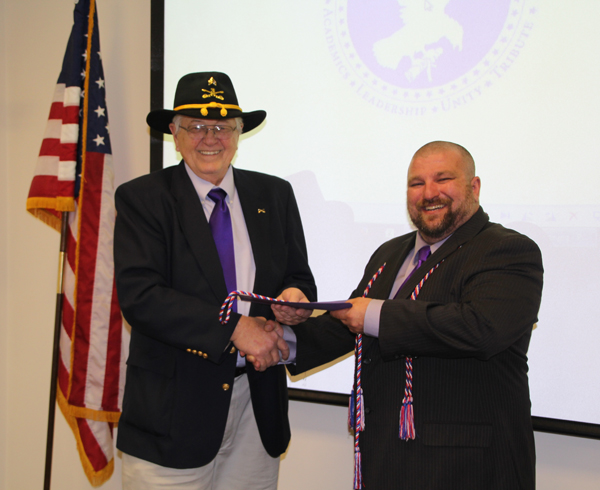Niagara University professor Bo Pikas was recently inducted into SALUTE, the Veterans honor society. Pikas is a member of the American Legion Post 1346, Grand Island. Pictured, he was inducted by Karl Hinterberger, assistant coordinator of Veteran Services, Niagara University.
