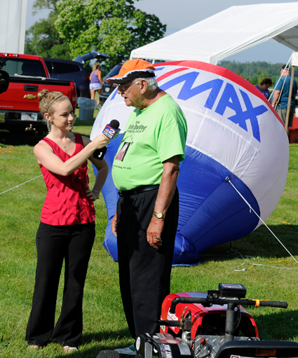 Pictured alongside the action, WGRZ Channel 2 reporter Erica Brecher interviews event founder Floyd Doring.