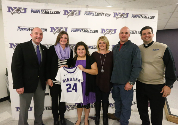 Caralyn Renyolds, center, with family, friends and NU officials.