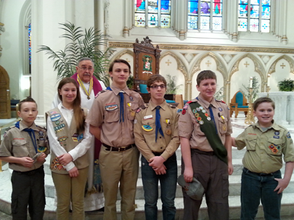 In the group picture, from left: Jonathan Minton, Emily Cohen, Father Sam Venne of St. Stephen R.C. Church, Cade Mongielo, Joseph Peters, Patrick Stouter, and Lucian Bodkin.