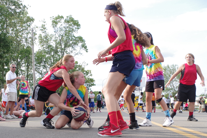Grand Islander Chase Luthringer of The Avengers looks to pass from her knees as Kayla Callaghan of Full Court Hoops, a team from Buffalo, defends during play in the 13-14 age bracket of the Gus Macker 3-on-3 Tournament Saturday. (Photos by Larry Austin)