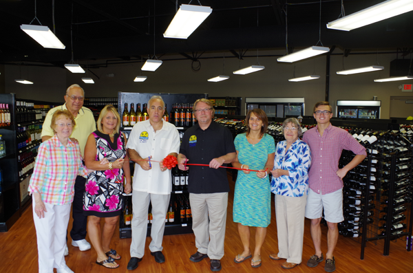 Grand Islanders Jim Atkinson and Tom Corrao are surrounded by family and friends at the ceremonial ribbon-cutting to their business Friday. (Photos by Larry Austin) 