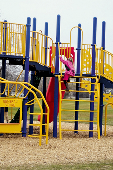 A child enjoys the new playground that David Brand, Chair of the Kaegebein Playground Committee, said is compact and has "so much to do."
