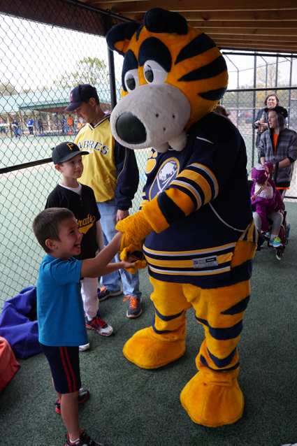 Sabretooth stepped out of the rain and greeted Miracle Leaguers in their dugout.
