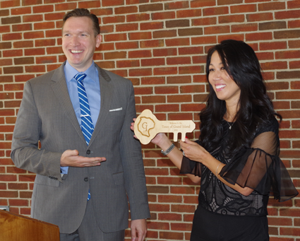 Town Supervisor Nathan McMurray presents Kim Pegula with a key to Grand Island Wednesday during a press conference announcing the One Buffalo Cupcake.