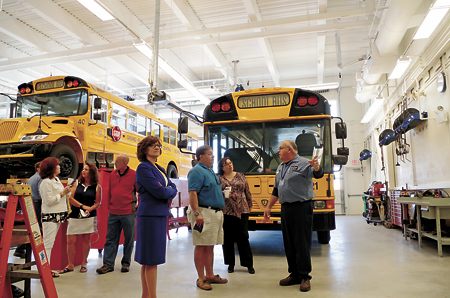 Chief mechanic Tim Blevins of the Grand Island Central School District Transportation Department gives a tour of the new Jack Burns Transportation Center Tuesday following a ceremonial ribbon-cutting and grand opening for the facility.