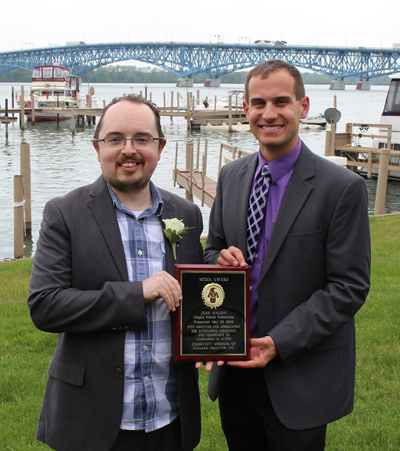 Joshua Maloni, managing editor at Niagara Frontier Publications, stands with Christian Hoffman, Community Missions Communications and Development Manager. Hoffman presented Maloni with a Public Relations/Media Award.