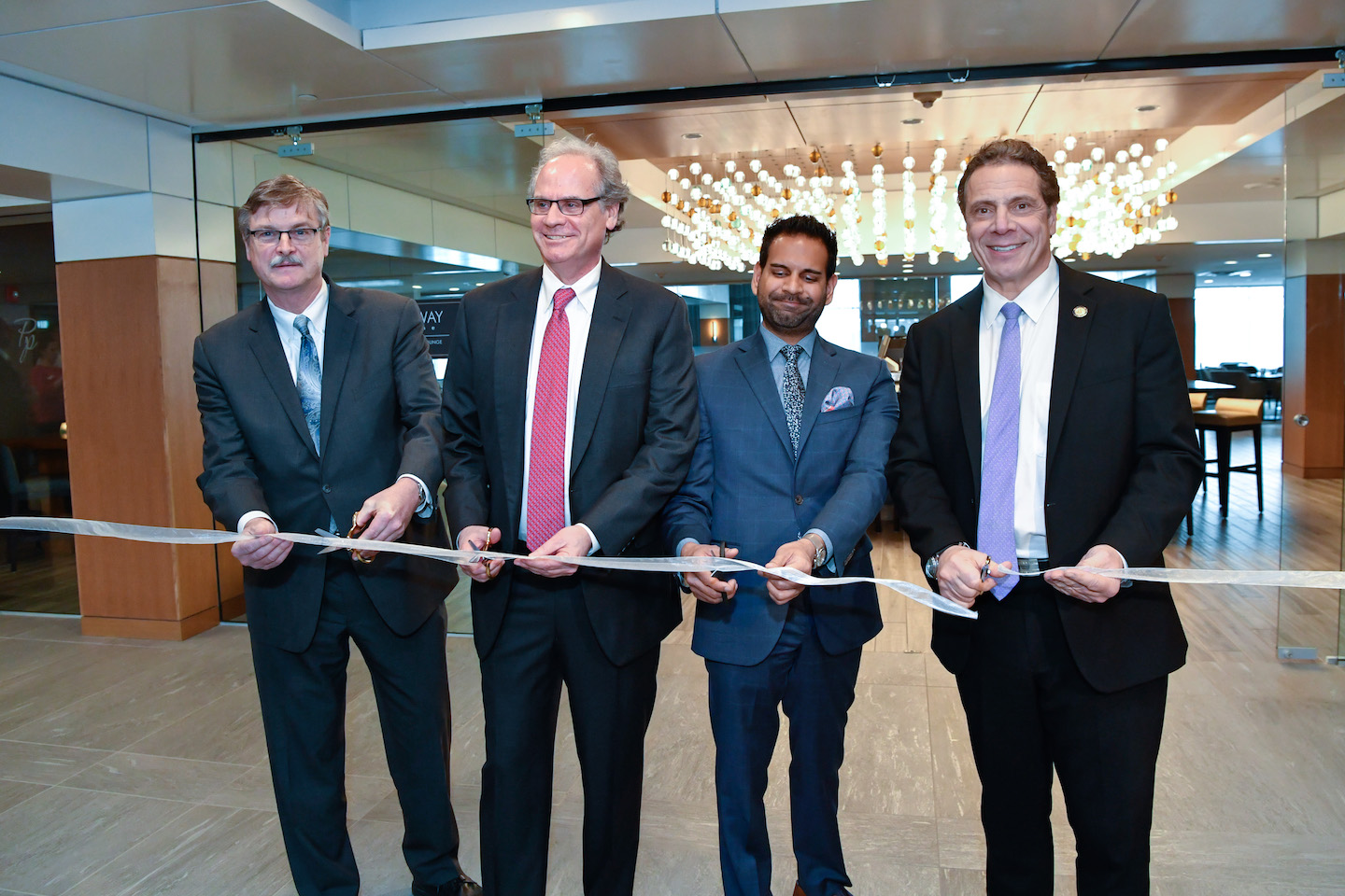 Gov. Andrew M. Cuomo celebrated the opening of the DoubleTree by Hilton in Niagara Falls and highlighted his proposal for additional economic development in Western New York. He is pictured, far right, with Niagara Falls Mayor Paul Dyster, Empire State Development President/CEO/Commissioner Howard Zemsky, and Merani Hotel Group President Faisal Merani (Photo courtesy of Gov. Cuomo's Flickr page)