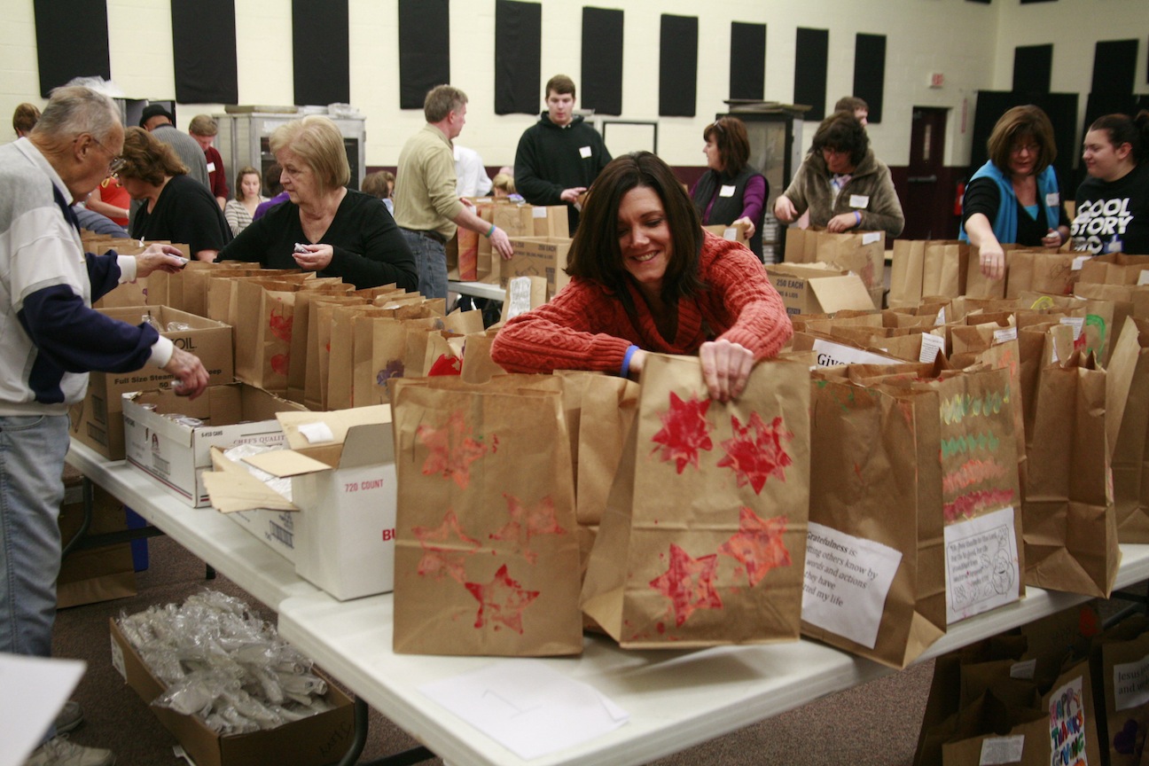 Volunteers help pack items to be donated.