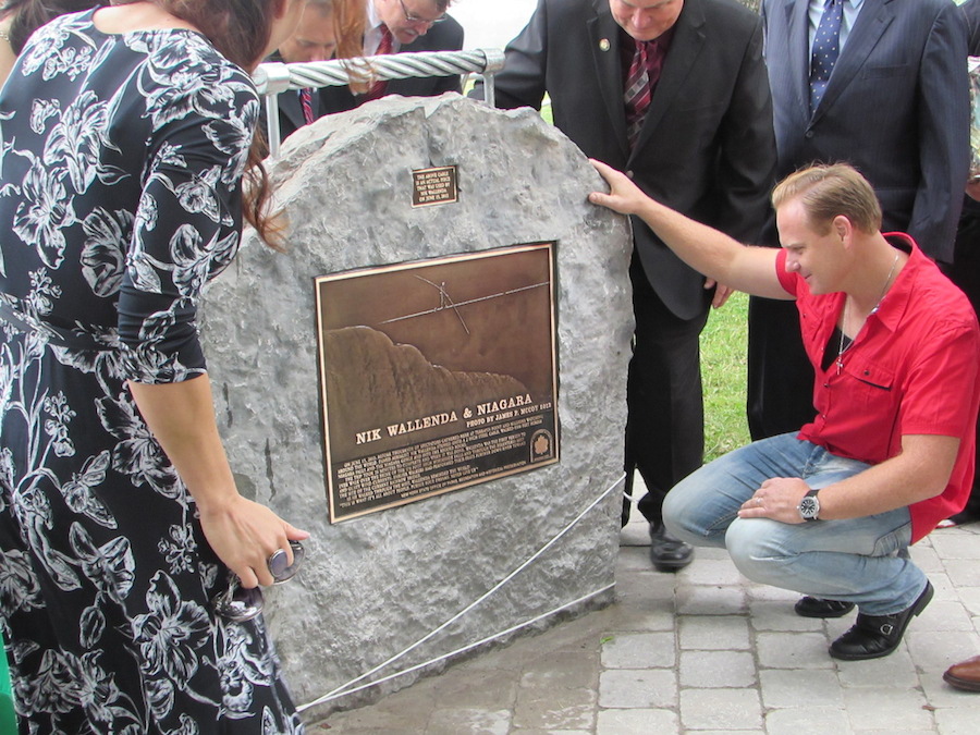 Nik Wallenda stands in front of a plaque mounted in his honor in Niagara Falls.
