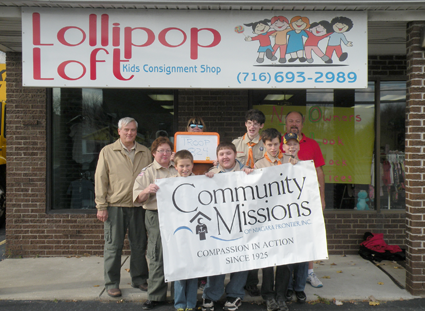 Members of Sanborn Boy Scout Troop 824 pose in front of Lollipop Loft Children's Consignment Store following their donation of more than 6,300 children's clothing items to Community Missions.