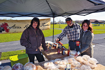 Shown is Margaret Darroch (left) representing Stone Hallow Farmers at the Town of Niagara Farmers Market. At right, are, Town of Niagara parks employee Roger Spurback and Town Recreation Department employee Mia Fontanarosa. (Photos by Marc Carpenter)