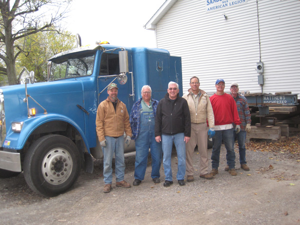 Matthews House Movers and Bill Sterner, chairman of the project (third from the left) start the move. 
