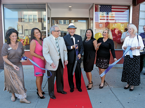 Louie Galanes cuts the ribbon during the grand opening of the new Louie's Texas Red Hots location at 18 Webster St., North Tonawanda.