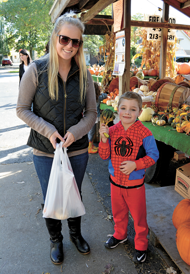 Allie Eckstein and Robert Stahlman (as Spiderman) of North Tonawanda pick out some small gourds.