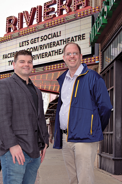 Riviera Theatre co-directors Gary J. Rouleau and Jim Pritchard stand together in front of the marquee.