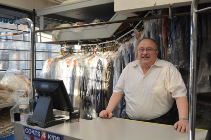 Russ Petrozzi, owner of Capitol Cleaners, stands at the front desk.