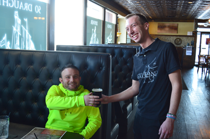 Jordan J. Toohey, right, serves a pint of Fuller's to customer Albert Fiocco of Niagara Falls.