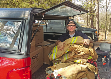 Michael DiPasquale of Adams Fire Co. loads up a vehicle with used firefighter gear for companies in need in rural Tennessee.