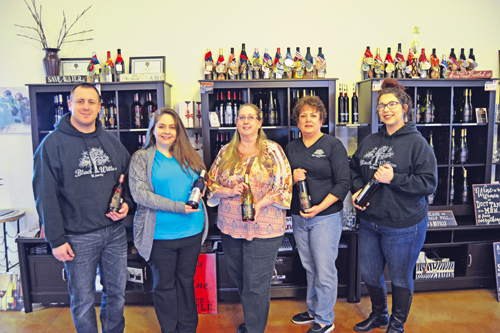 Black Willow Winery staffers display a variety of wines. From left are staff members Jonathan Little, Amanda Mitchell, owner Cynthia West-Chamberlain and staff members Rebecca Scott and Brianna Beane.