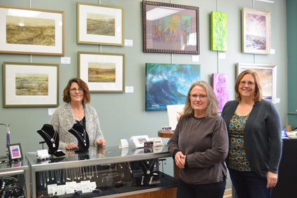 From left: Local artists Dawn M. DiGesare, Susan M. Miller and Deanna Weinholtz stand by their artwork at the River Gallery, where they all volunteer and sell pieces.