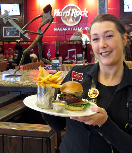 Hard Rock server Tasha Huffman proudly displays a Heineken brisket burger inside the Niagara Falls cafe on Prospect Street.