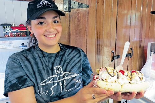 Ice cream manager Lexi Alfiere holds a banana split.