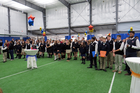 Students look on as the ceremony unfolds and the ribbon is cut.