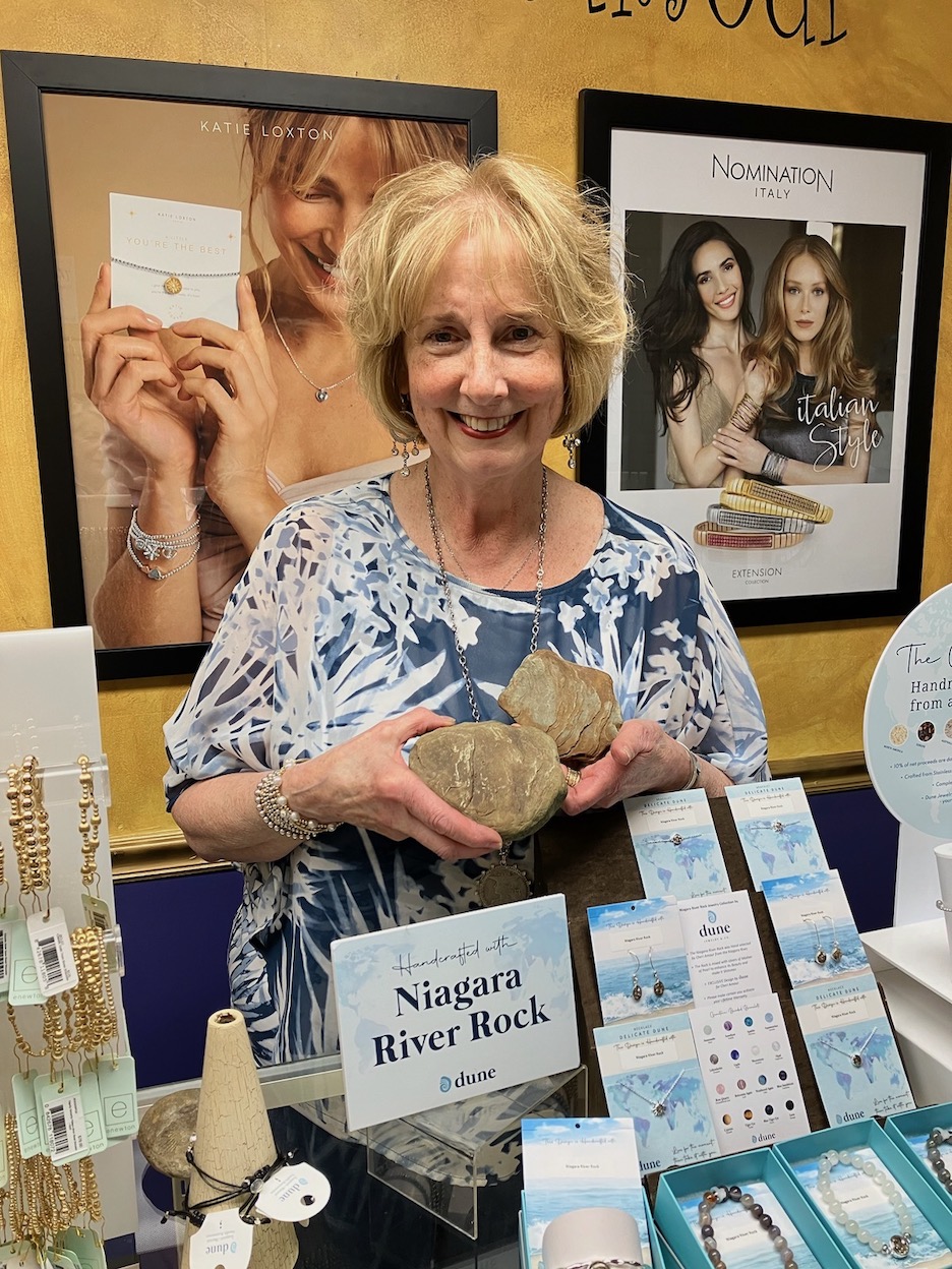 Chéri Amour's Cheri Clark is shown with the Dune Jewelry & Co. Niagara River rock collection.
