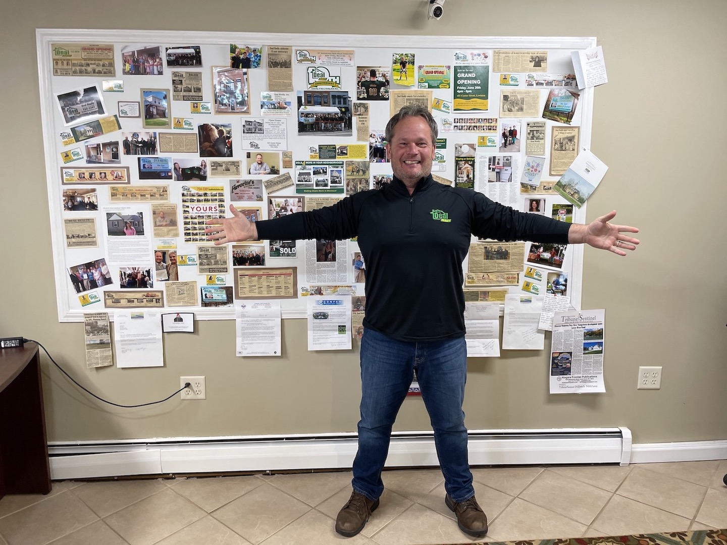 Inside his center Street office, Tom Deal stands in front of a wall of accomplishments achieved over the past decade-plus.
