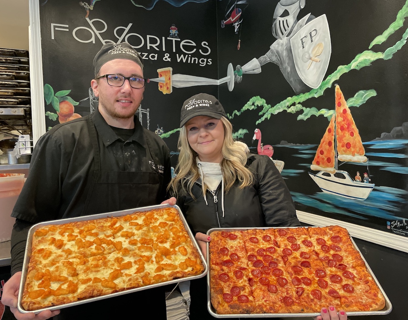 Favorites Pizza & Wings managers Austin Regis and Aurora Campbell show off some of WNY's Best Pizza.