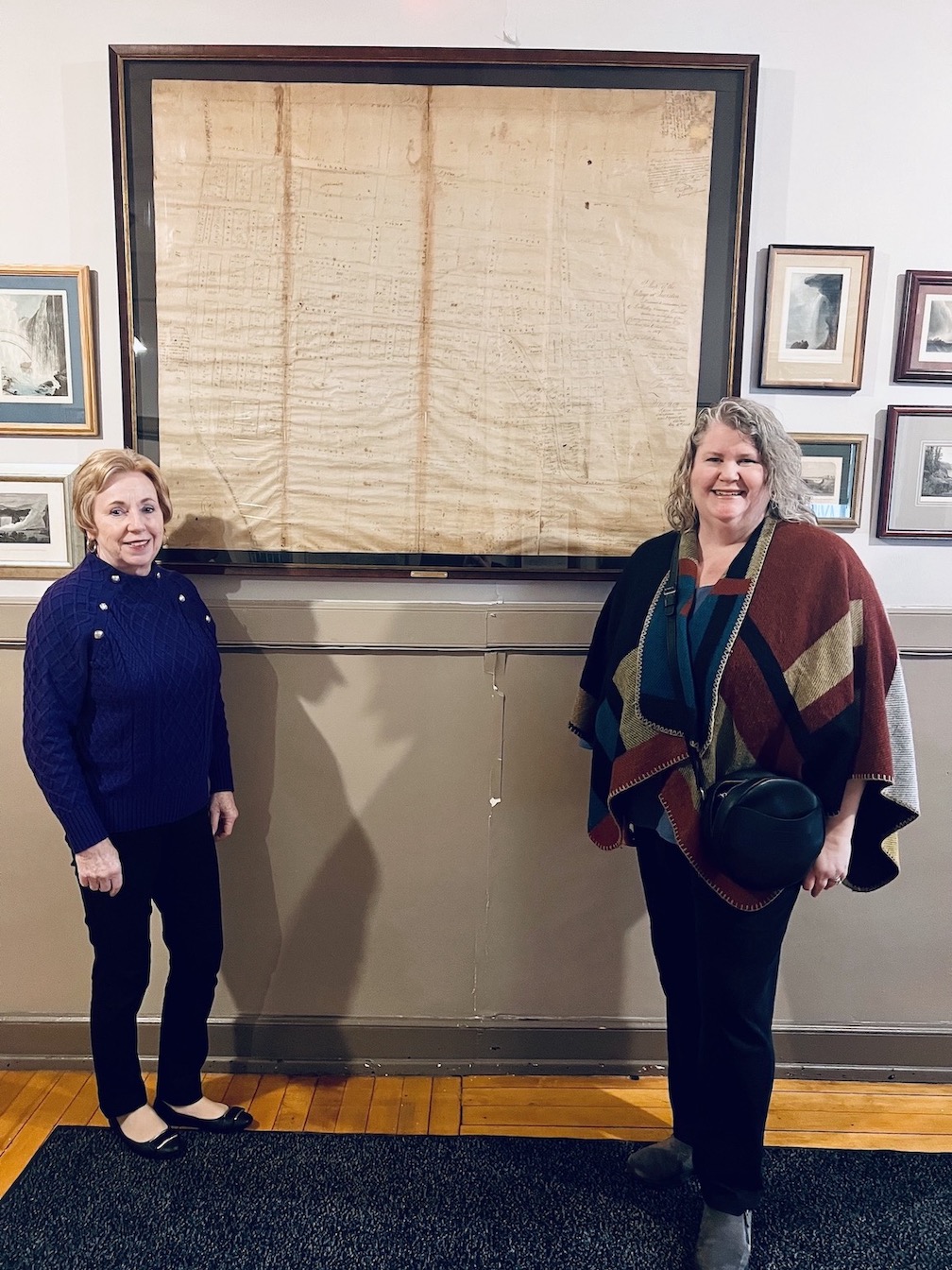 Village of Lewiston Mayor Anne Welch is shown with Mary Helen Miskuly in front of the historic Lewiston map in the main hallway of the Red Brick Municipal Building, 145 N. Fourth St. The map was donated by Peter Barton Hutt, and is framed with a special ultraviolet Plexiglas. (Submitted)