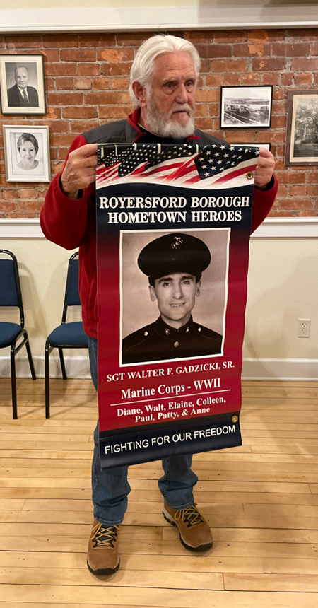 Vince Canosa holds a sample `Hometown Heroes` banner.