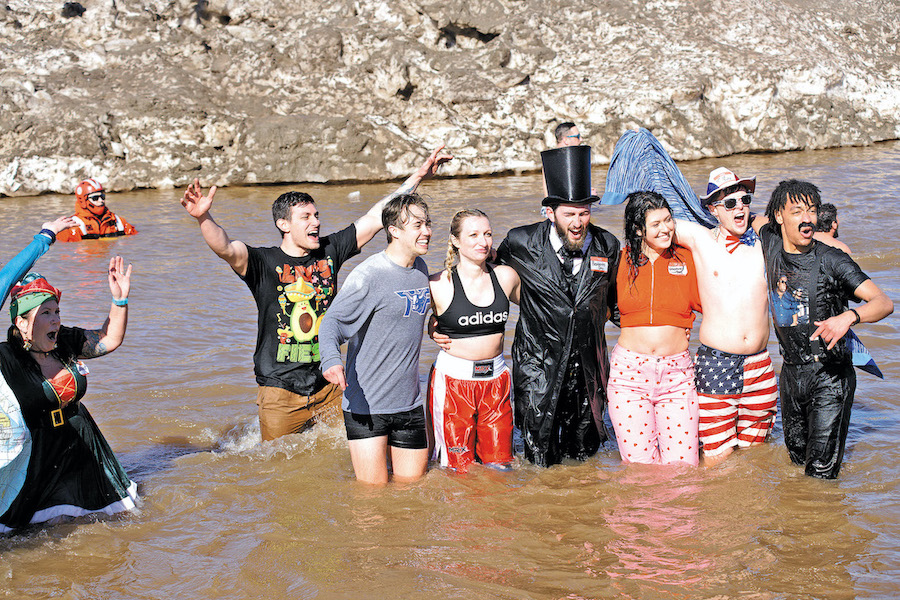 Partiers take on the icy Lake Ontario waters at last year's Swim for Sight. (File photo).