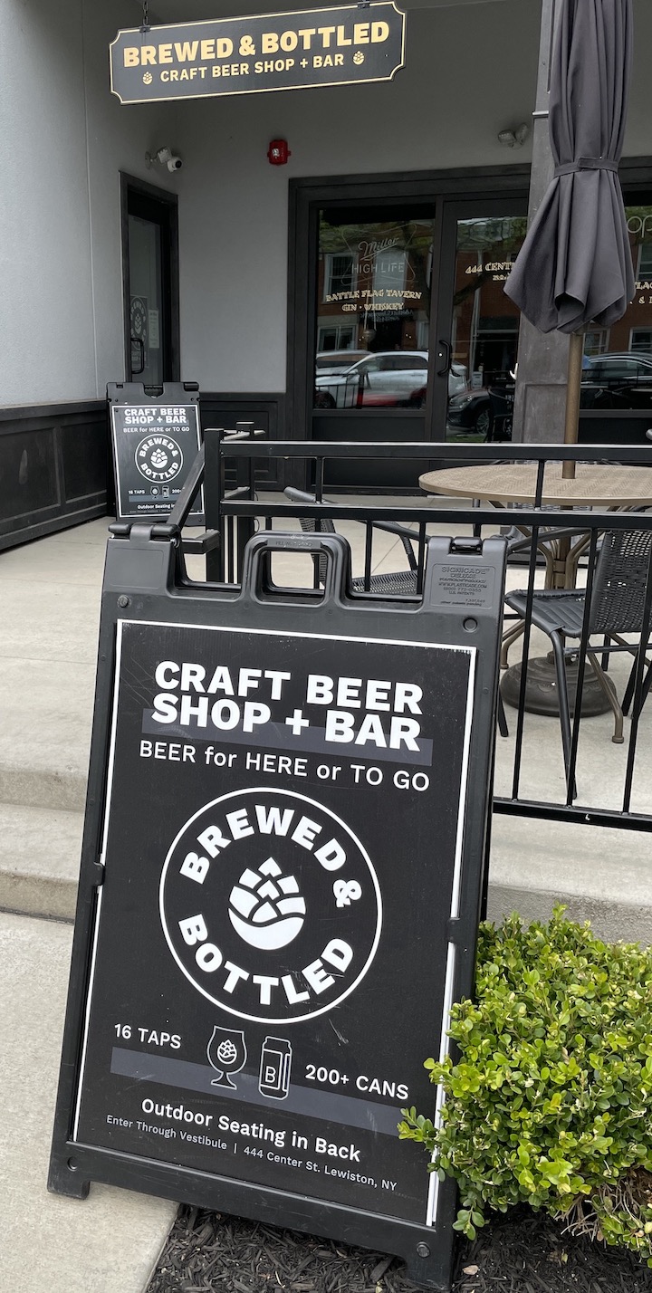 Brewed and Bottled Craft Beer Shop utilizes signs to attract customers to its off-Center Street site. Owner Chris Budde said, `We have two A-frame signs out front due to our business being located through the vestibule and hidden. We receive many calls and messages weekly from customers that can not find our business. The a frame in the garden on the property is to catch people's eye; the A-frame near the door is to indicate where the entrance is located.`