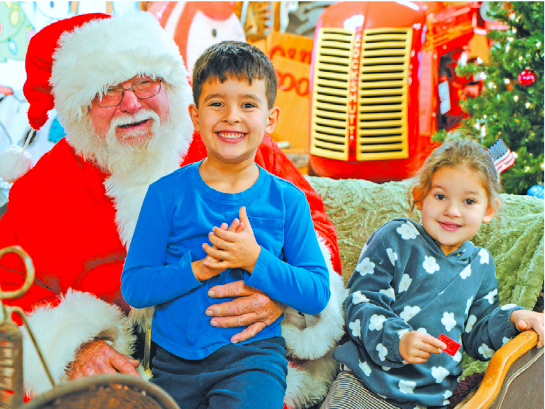 Santa visits with little ones at last year's `Christmas in the Village` celebration. (Submitted/file photo)