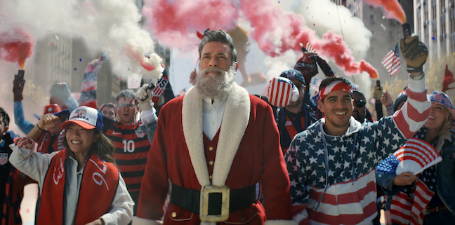 Santa (Jon Hamm) is pictured as part of FOX Sports' Qatar 2022 FIFA World Cup ad, which also features Tom Brady, Mariah Carey and Ellie Kemper.  (Image courtesy and copyright FOX Sports Press Pass)
