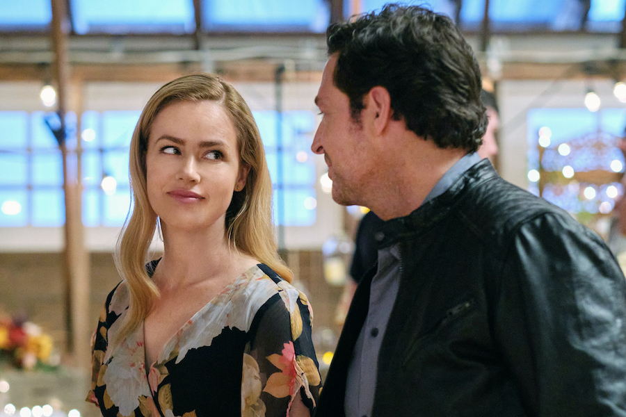 Abby is a successful executive moving to Paris and planning to marry Edward. Life is perfect until she learns her divorce to high school sweetheart, Luke, is not exactly official. Shown are `Marry Go Round` stars Amanda Schull and Brennan Elliott. (Photo ©2022 Hallmark Media/photographer: Bettina Strauss)