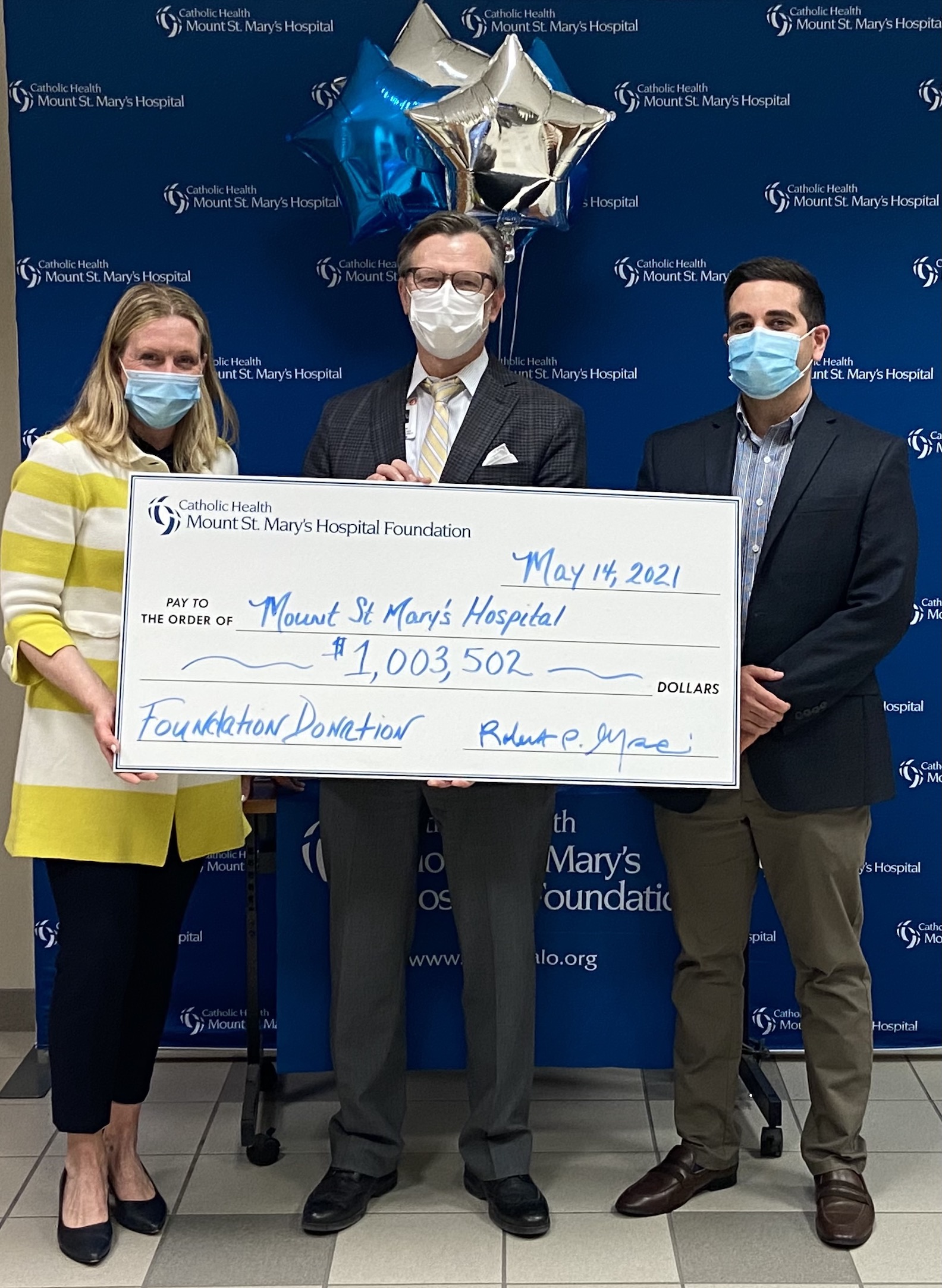 Pictured: Mount St. Mary's Hospital Foundation Executive Director Julie Berrigan, left, and Treasurer Robert Ingrasci, right, present a check to CJ Urlaub, hospital president.