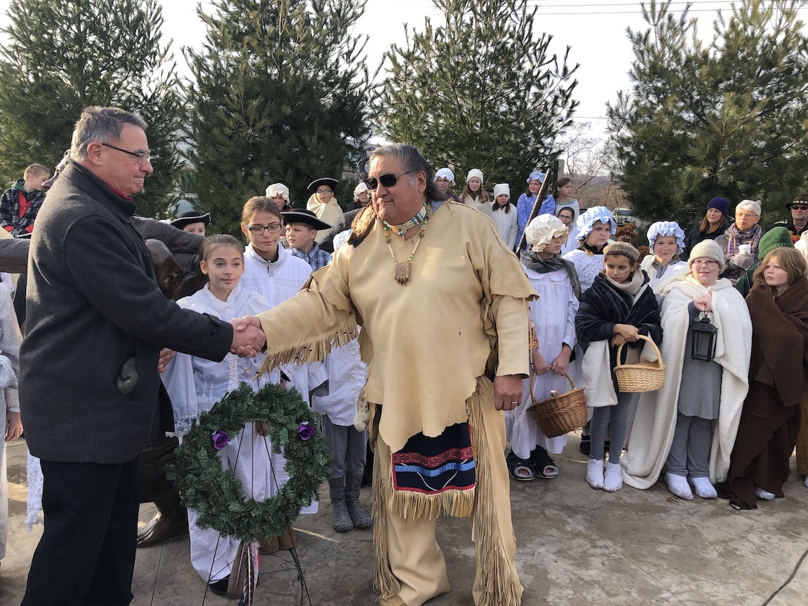 Ken Slaugenhoupt, president of the Historical Association of Lewiston, shakes hands with Neil Patterson, a member of the Tuscarora Council and Lewiston's nation liaison.
