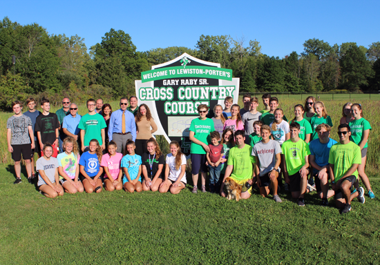 The Raby family and Lew-Port cross country team members gather for a group photo. (Contributed photo)